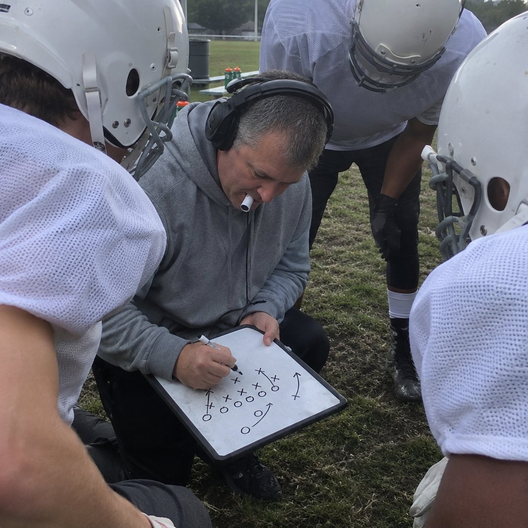An offensive line coach developing practice material